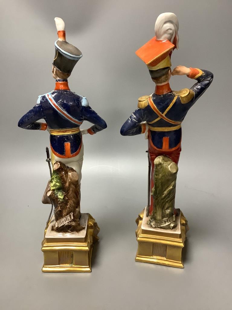 A pair of Italian porcelain figures and a pair of Continental figural candlesticks